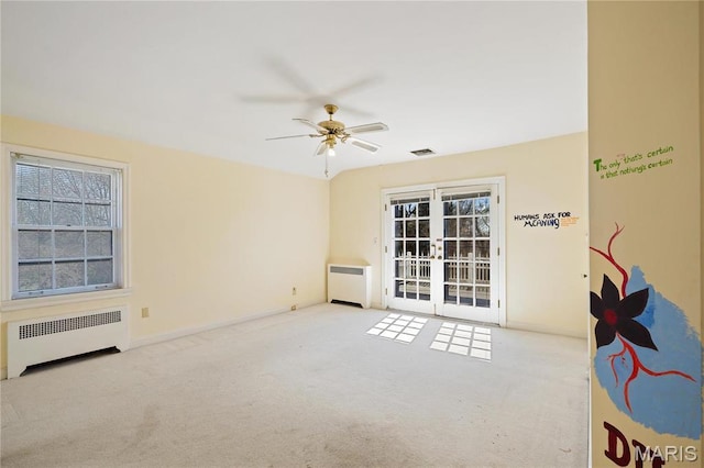 910 Kent Rd, Ladue, MO 63124 - spare room with radiator, light carpet, french doors, and ceiling fan