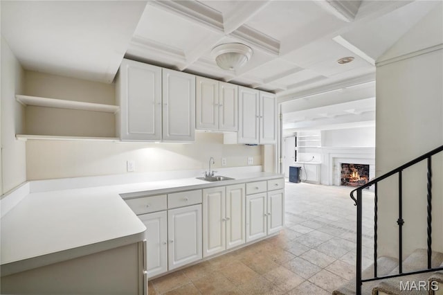 910 Kent Rd, Ladue, MO 63124 - kitchen featuring open shelves, a lit fireplace, coffered ceiling, white cabinets, and light countertops