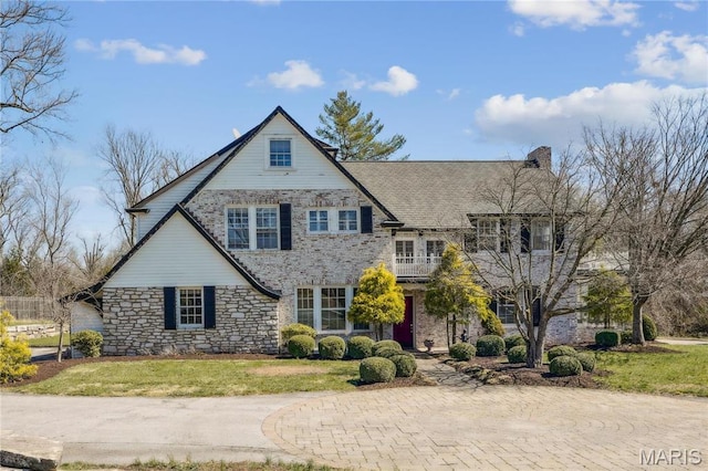 910 Kent Rd, Ladue, MO 63124 - view of front of home with stone siding, a front lawn, and a chimney