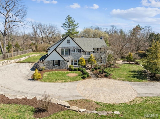 910 Kent Rd, Ladue, MO 63124 - view of front facade featuring stone siding, a balcony, and curved driveway