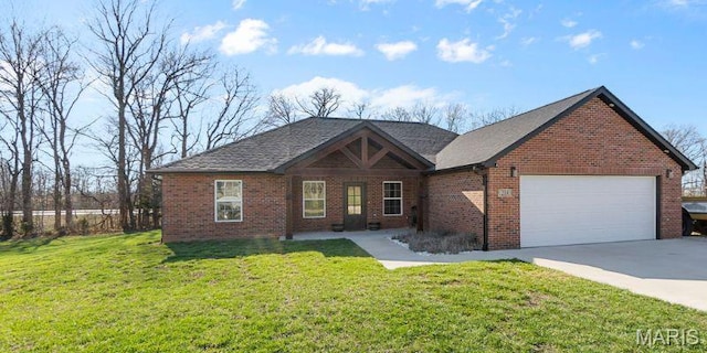 214 Gladiola St, Jackson, MO 63755 - view of front facade with brick siding, a front lawn, driveway, and an attached garage