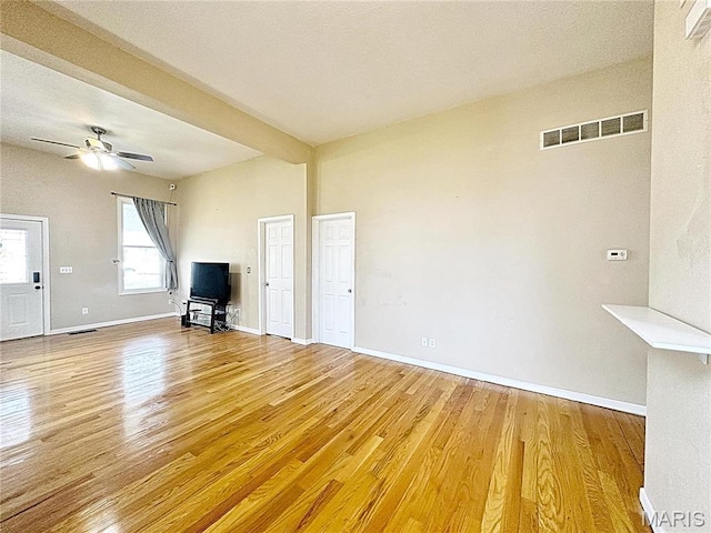 703 S Main St, Troy, IL 62294 - unfurnished living room featuring wood finished floors, baseboards, and a ceiling fan