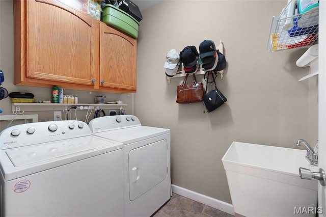 2009 Weber Heights Dr, Washington, MO 63090 - laundry room featuring washing machine and dryer, cabinet space, and baseboards