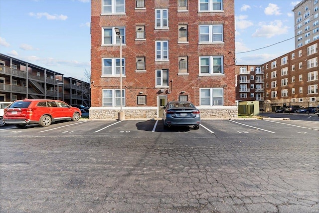 view of apartment building / complex featuring uncovered parking
