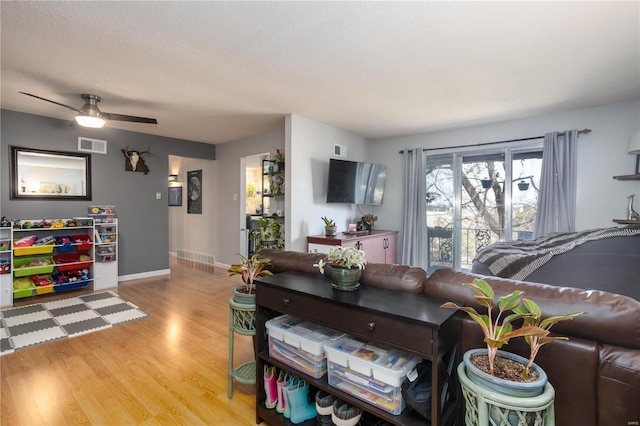 11921 Villa Dorado Dr Unit F, Saint Louis, MO 63146 - living room featuring wood finished floors, a ceiling fan, baseboards, and a textured ceiling