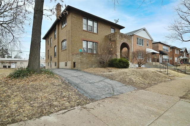 7227 Dartmouth Ave, Saint Louis, MO 63130 - view of front of home featuring a chimney, brick siding, and a residential view