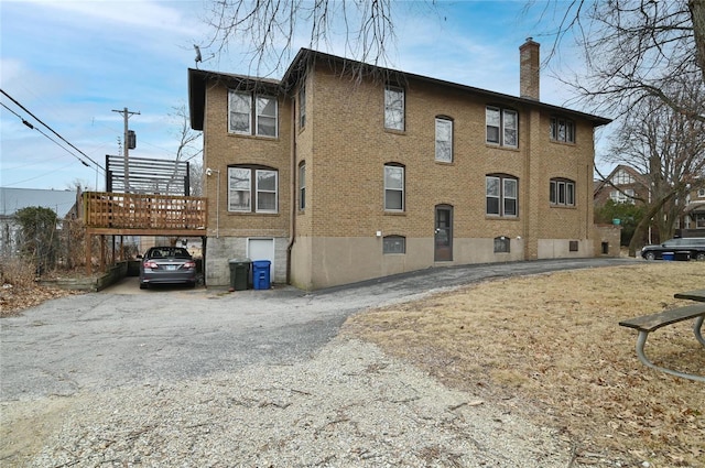 7227 Dartmouth Ave, Saint Louis, MO 63130 - view of building exterior featuring asphalt driveway and a carport