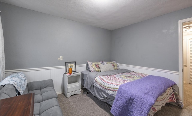 15105 Transit Rd, Saint Robert, MO 65584 - carpeted bedroom with wainscoting and a textured ceiling