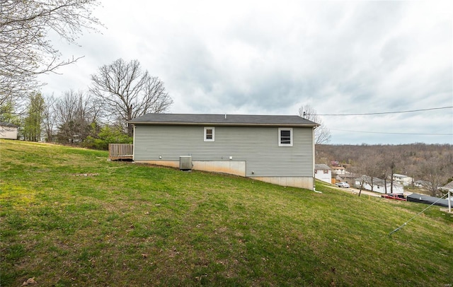 15105 Transit Rd, Saint Robert, MO 65584 - rear view of house featuring a lawn and central air condition unit