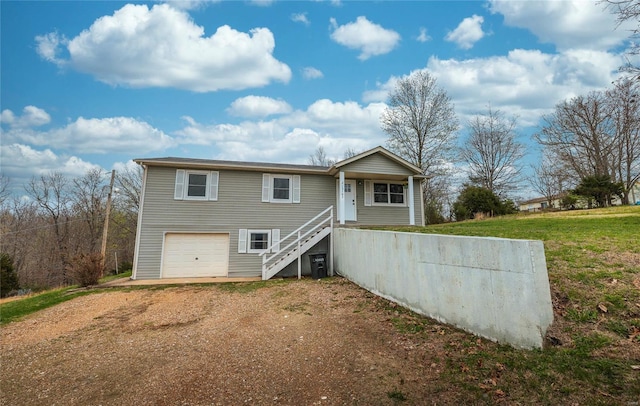 15105 Transit Rd, Saint Robert, MO 65584 - view of front of home featuring driveway, stairs, a garage, and a front yard