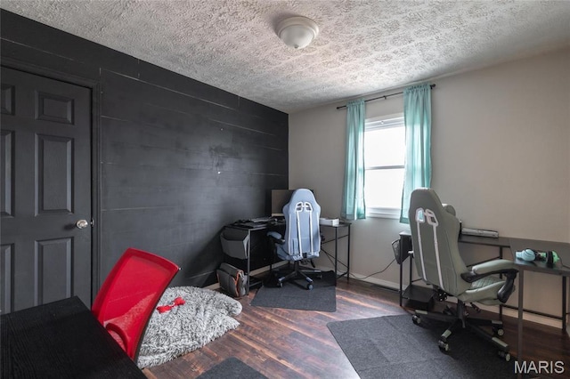 15105 Transit Rd, Saint Robert, MO 65584 - home office with a textured ceiling, wood finished floors, and an accent wall