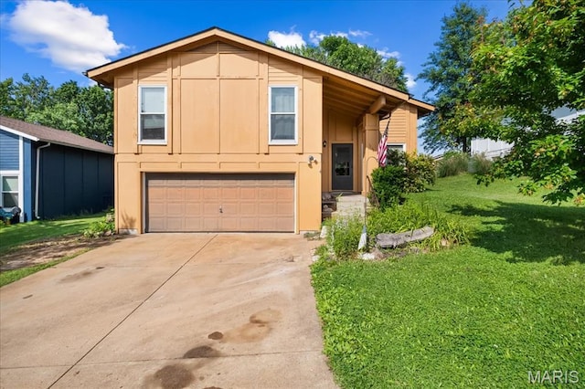1739 Fairfax Dr, Barnhart, MO 63012 - view of front facade with concrete driveway, a garage, and a front yard