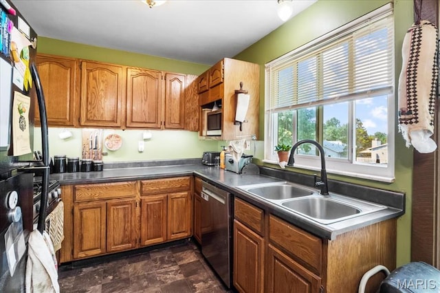 1739 Fairfax Dr, Barnhart, MO 63012 - kitchen featuring stainless steel dishwasher, a sink, brown cabinetry, freestanding refrigerator, and stone finish floors