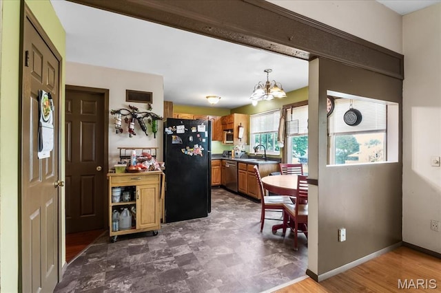 1739 Fairfax Dr, Barnhart, MO 63012 - kitchen with freestanding refrigerator, a chandelier, stainless steel dishwasher, a sink, and dark countertops