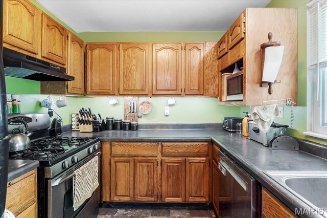 1739 Fairfax Dr, Barnhart, MO 63012 - kitchen with under cabinet range hood, appliances with stainless steel finishes, dark countertops, and brown cabinets