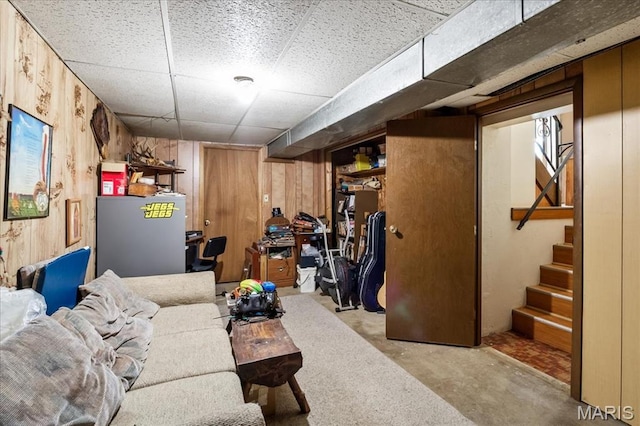 1739 Fairfax Dr, Barnhart, MO 63012 - living area with a drop ceiling, wood walls, stairs, and concrete flooring