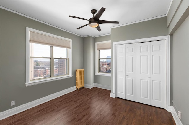 4440 Lindell Blvd Unit 701, Saint Louis, MO 63108 - unfurnished bedroom with dark wood finished floors, ornamental molding, a closet, baseboards, and ceiling fan