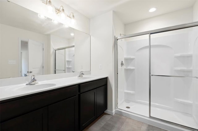16804 River Stone Dr, Florissant, MO 63031 - bathroom featuring a shower stall, double vanity, and tile patterned flooring