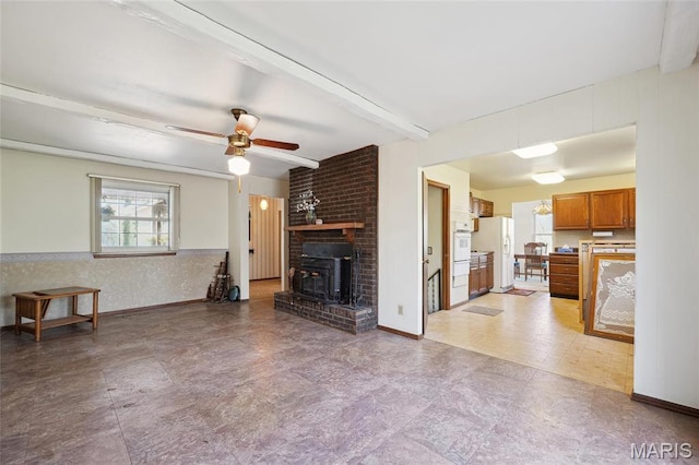 32 Oak Forest Dr, Saint Charles, MO 63303 - living room featuring beamed ceiling, a ceiling fan, and a wood stove