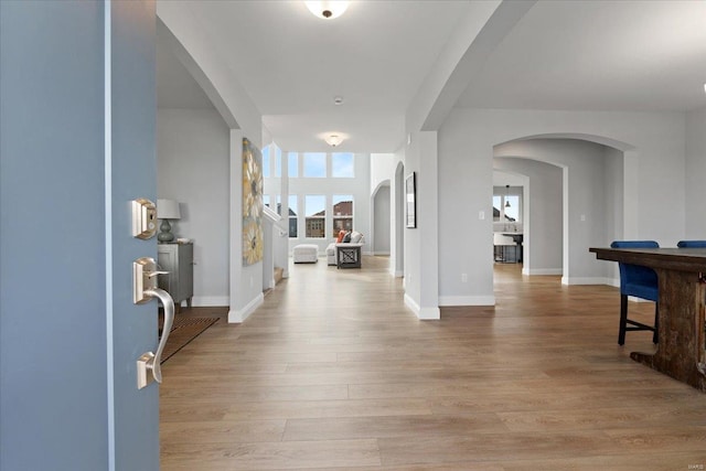 5 Canebrake Ct, Wentzville, MO 63385 - foyer featuring light wood-type flooring, arched walkways, and baseboards