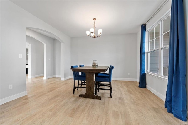5 Canebrake Ct, Wentzville, MO 63385 - dining space with a chandelier, arched walkways, light wood finished floors, and baseboards