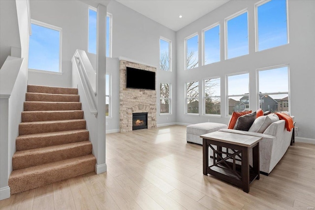 5 Canebrake Ct, Wentzville, MO 63385 - living area with plenty of natural light, a high ceiling, stairway, light wood-style floors, and a fireplace