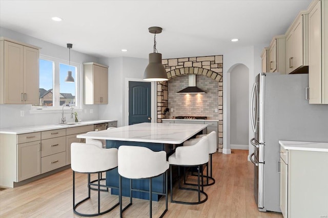 5 Canebrake Ct, Wentzville, MO 63385 - kitchen featuring wall chimney exhaust hood, stainless steel appliances, a kitchen island, light wood-type flooring, and recessed lighting