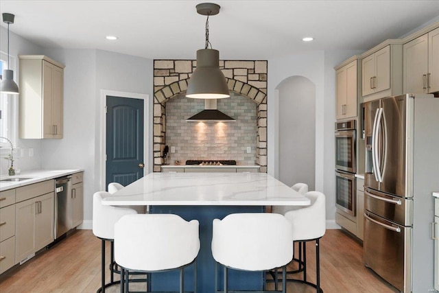 5 Canebrake Ct, Wentzville, MO 63385 - kitchen featuring stainless steel appliances, a sink, light wood-style flooring, tasteful backsplash, and recessed lighting