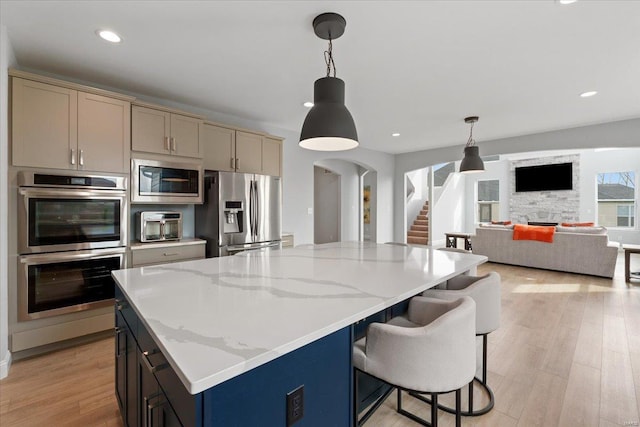 5 Canebrake Ct, Wentzville, MO 63385 - kitchen featuring stainless steel appliances, light wood-style floors, light stone countertops, decorative light fixtures, and recessed lighting