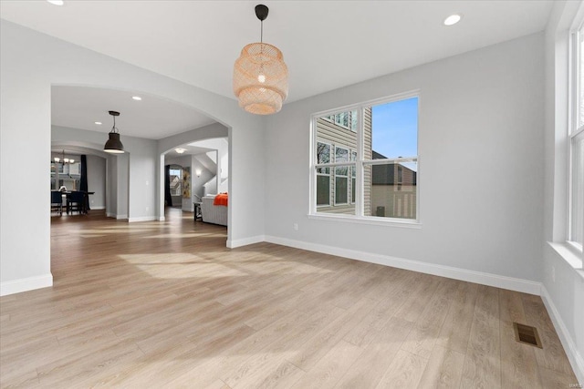 5 Canebrake Ct, Wentzville, MO 63385 - unfurnished dining area featuring arched walkways, light wood-type flooring, baseboards, recessed lighting, and a chandelier