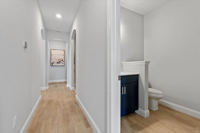 5 Canebrake Ct, Wentzville, MO 63385 - hall with arched walkways, light wood finished floors, and baseboards
