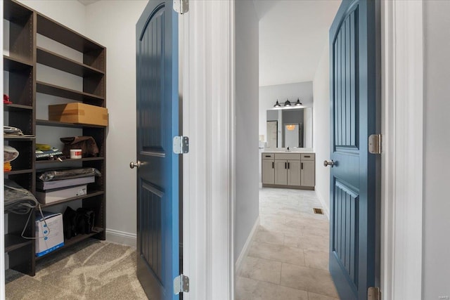 5 Canebrake Ct, Wentzville, MO 63385 - corridor featuring light tile patterned floors, baseboards, and a sink