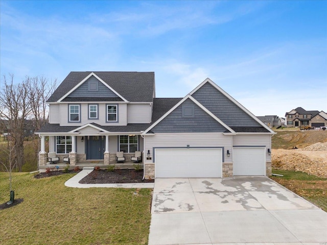 5 Canebrake Ct, Wentzville, MO 63385 - craftsman-style house with stone siding, an attached garage, a porch, driveway, and a front yard