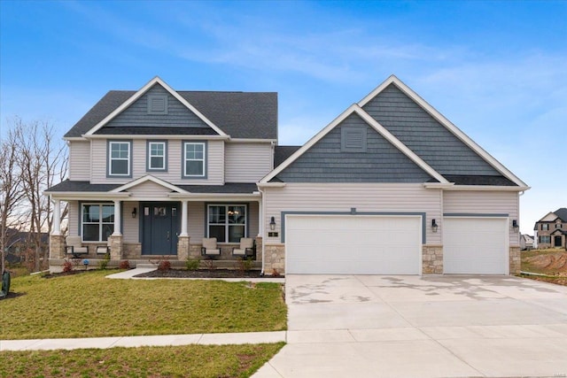 5 Canebrake Ct, Wentzville, MO 63385 - craftsman inspired home featuring an attached garage, driveway, stone siding, a front lawn, and covered porch