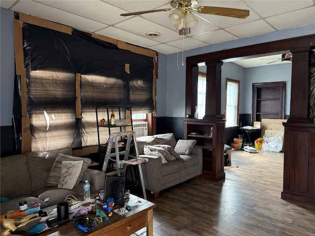 600 N 7th St, Louisiana, MO 63353 - living room featuring a ceiling fan, ornate columns, a paneled ceiling, wainscoting, and wood finished floors