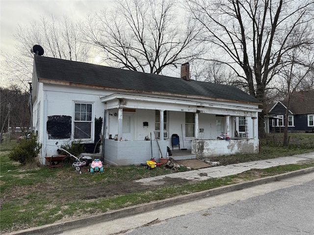 600 N 7th St, Louisiana, MO 63353 - view of front of property with a porch, a chimney, and a shingled roof