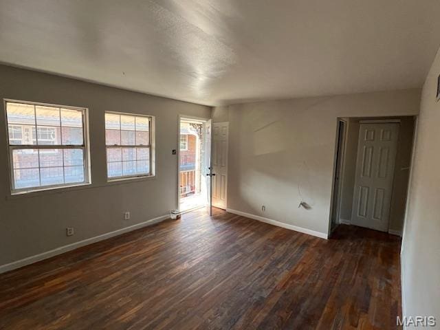 8440 N Broadway N, Saint Louis, MO 63147 - unfurnished room with dark wood finished floors and baseboards