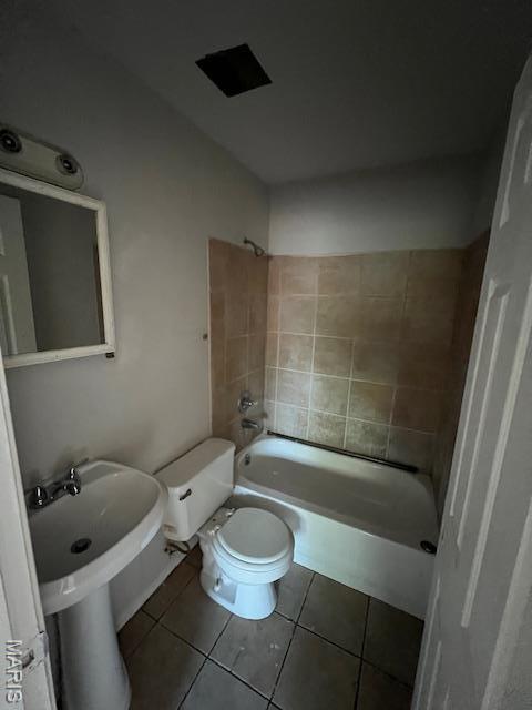 8440 N Broadway N, Saint Louis, MO 63147 - bathroom featuring tile patterned floors, toilet, and  shower combination