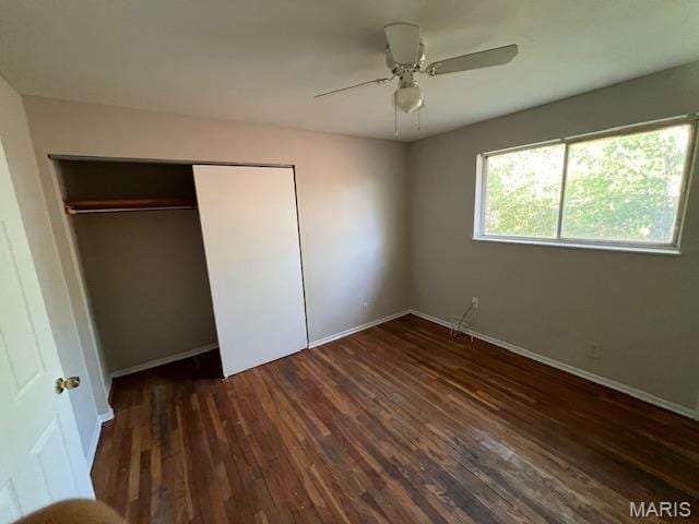 8440 N Broadway N, Saint Louis, MO 63147 - unfurnished bedroom with wood finished floors, a closet, baseboards, and a ceiling fan