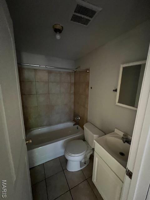 8440 N Broadway N, Saint Louis, MO 63147 - full bath with tile patterned flooring, toilet, vanity, and washtub / shower combination