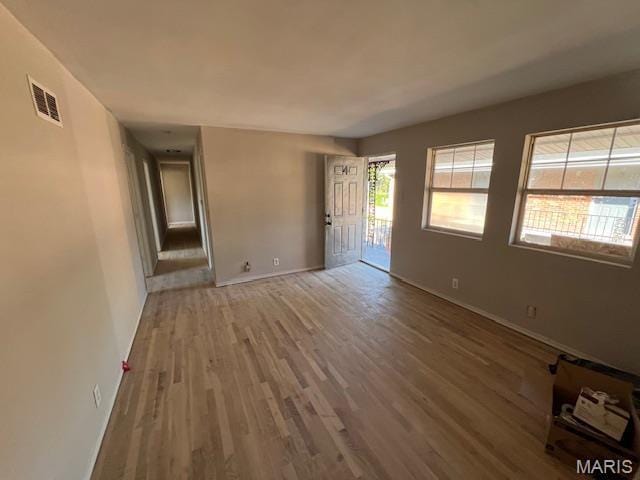 8440 N Broadway N, Saint Louis, MO 63147 - empty room with wood finished floors and baseboards