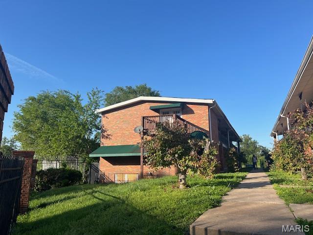 8440 N Broadway N, Saint Louis, MO 63147 - view of property exterior with a balcony and brick siding