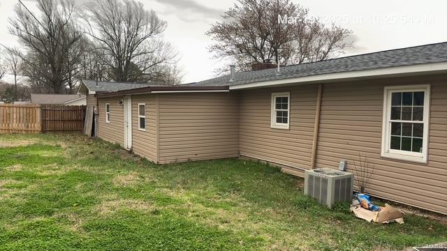 rear view of house featuring central AC unit