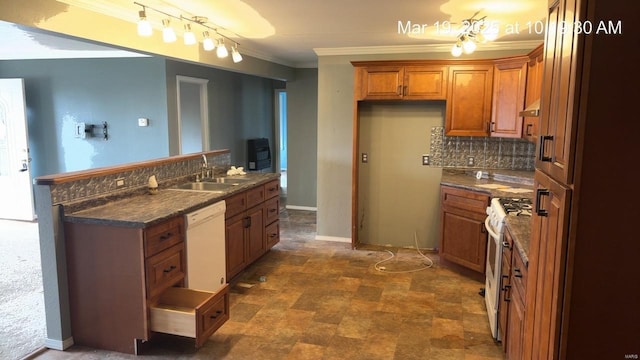 kitchen with a sink, brown cabinets, white appliances, dark countertops, and ornamental molding