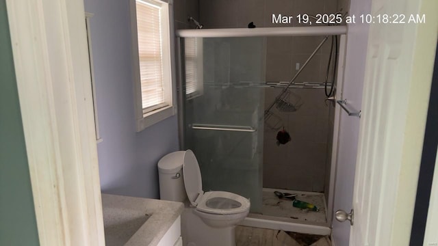 full bath with a shower stall, toilet, and vanity