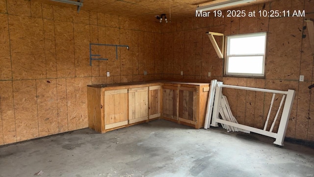 misc room with unfinished concrete flooring