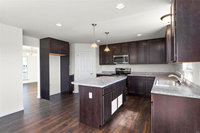 5048 Knotty Alder Dr, Imperial, MO 63052 - kitchen with a sink, appliances with stainless steel finishes, a center island, dark wood-style floors, and dark brown cabinetry