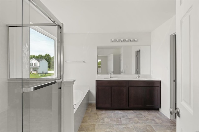 5048 Knotty Alder Dr, Imperial, MO 63052 - full bathroom with a bath, baseboards, plenty of natural light, and double vanity