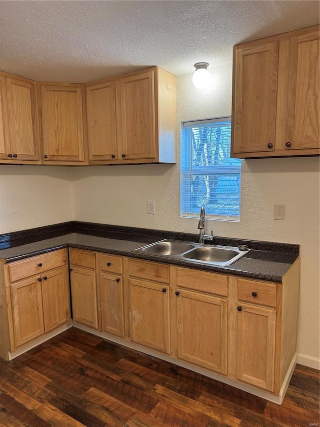 2012 Bradley, Kennett, MO 63857 - kitchen featuring a sink, dark wood-type flooring, dark countertops, and a textured ceiling