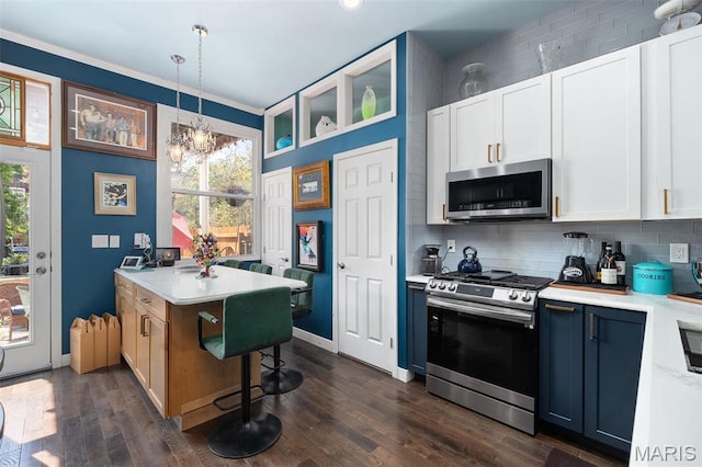 910 Rutger St, Saint Louis, MO 63104 - kitchen featuring appliances with stainless steel finishes, light countertops, decorative backsplash, a chandelier, and crown molding